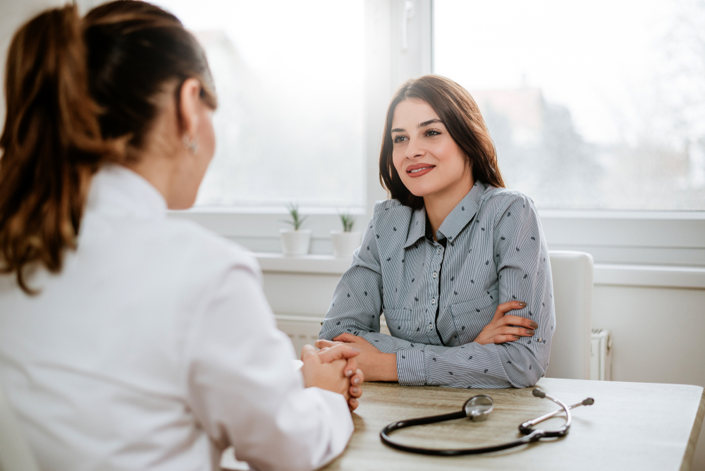 woman talking with doctor at gynecology appointment.