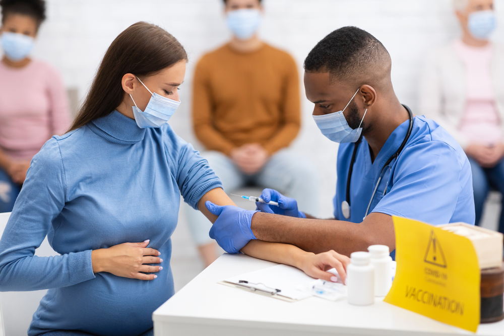 Pregnant Lady In Face Mask Getting Vaccinated .Against Coronavirus