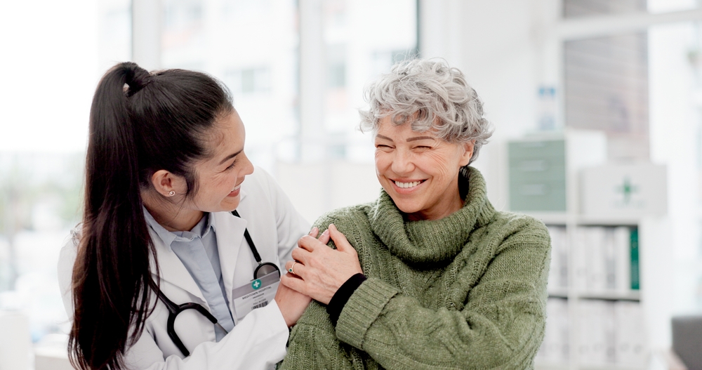 older woman talking to doctor.